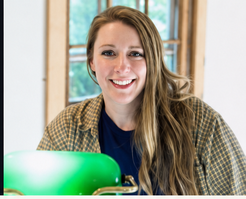 Kate McGraw in her studio beside a green banker's lamp